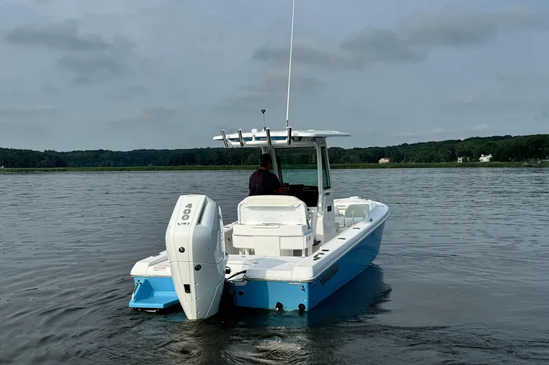 Slide: The Image of 2024 Everglades 253 Center Console boat on calm water. - 6