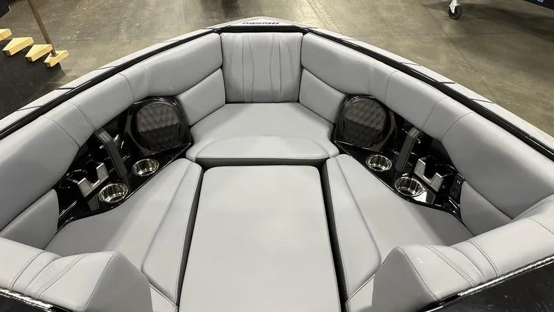Slide: The Image of 2024 Malibu 22 LSV boat interior with luxurious gray seating and cup holders. - 3