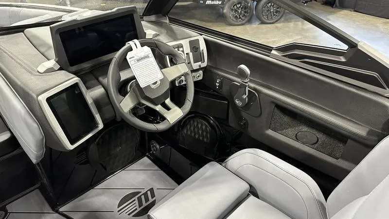 Slide: The Image of 2024 Malibu 22 LSV boat interior with modern dashboard and steering wheel. - 7