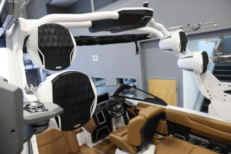 Slide: The Image of 2024 Malibu M220 boat interior with premium audio system and luxurious seating. - 12