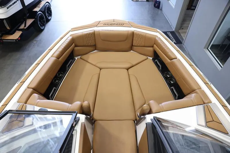 Slide: The Image of 2024 Malibu M220 boat with tan leather seating in the bow area. - 13