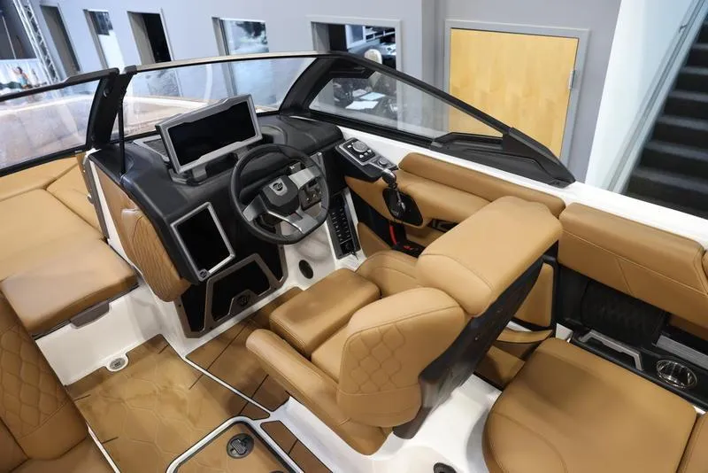Slide: The Image of 2024 Malibu M220 boat interior with tan leather seats and modern dashboard. - 15