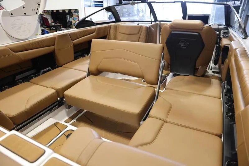 Slide: The Image of 2024 Malibu M220 boat interior with luxurious tan leather seating. - 18