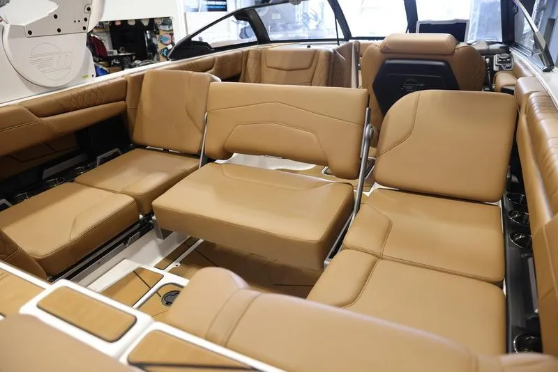 Slide: The Image of 2024 Malibu M220 boat interior with tan leather seating and modern design. - 20