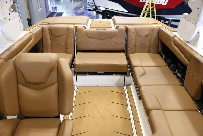 Slide: The Image of 2024 Malibu M220 boat interior with luxurious tan leather seating. - 21