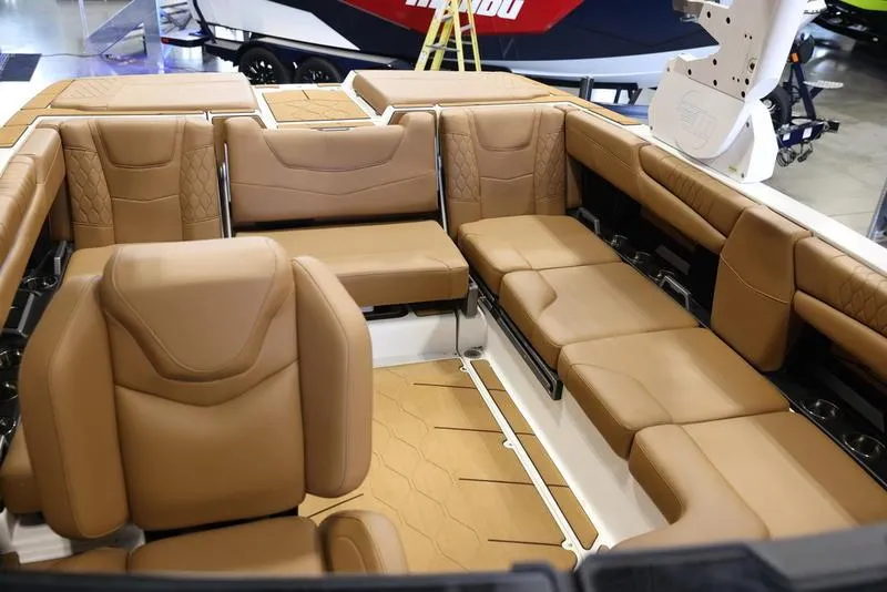 Slide: The Image of 2024 Malibu M220 boat interior with luxurious tan leather seating. - 22