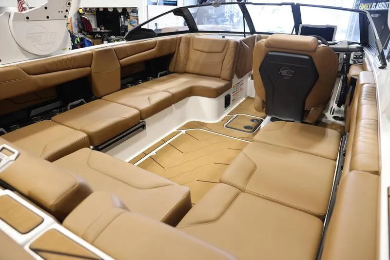 Slide: The Image of 2024 Malibu M220 boat interior with luxurious tan leather seating. - 23