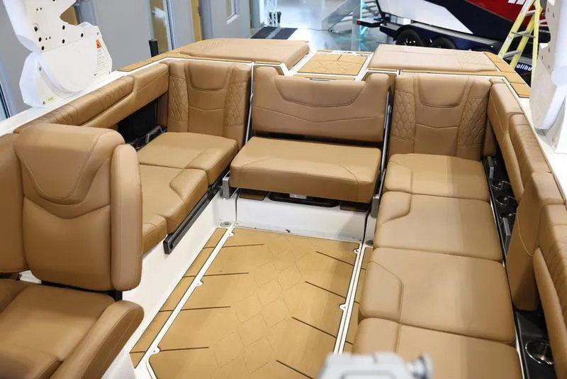 Slide: The Image of 2024 Malibu M220 boat interior with luxurious tan leather seating. - 24