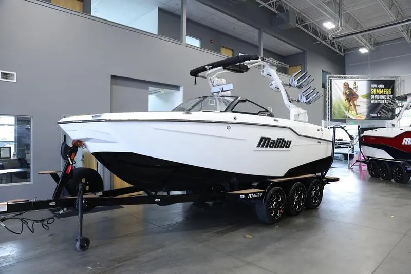 Slide: The Image of 2024 Malibu M220 boat displayed in a showroom. - 3