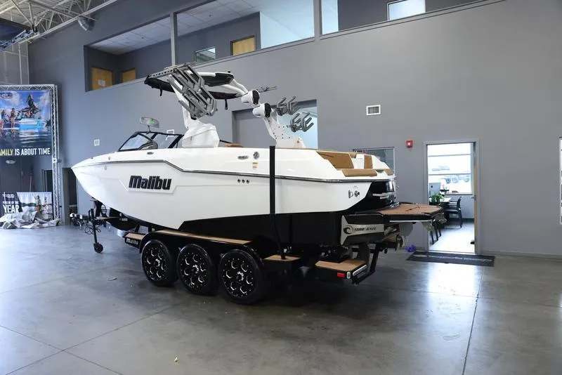 Slide: The Image of 2024 Malibu M220 boat on trailer in showroom. - 4