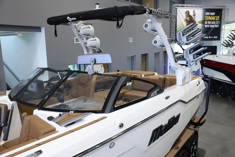 Slide: The Image of 2024 Malibu M220 boat with advanced wakeboard tower and luxurious interior on display. - 8