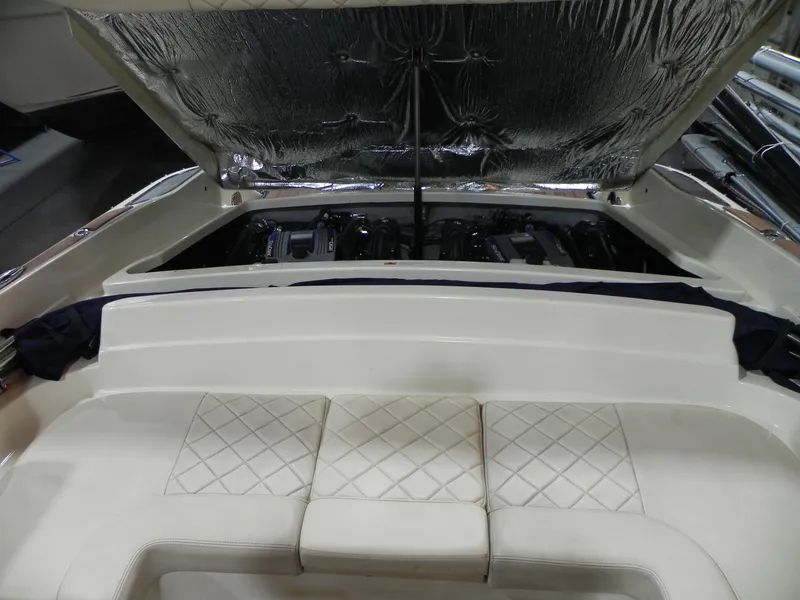 Slide: The Image of 2015 Chris-Craft 28 Heritage Corsair engine compartment with open hatch and cushioned seating. - 13