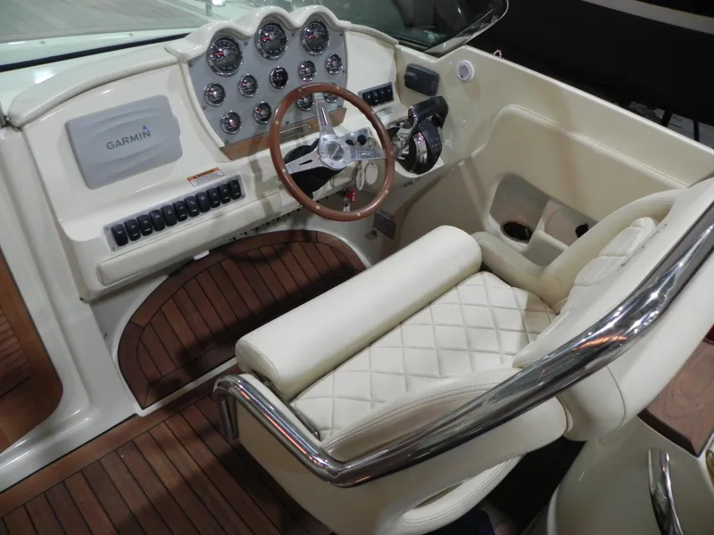 Slide: The Image of 2015 Chris-Craft 28 Heritage Corsair cockpit with leather seating and wooden dashboard. - 22