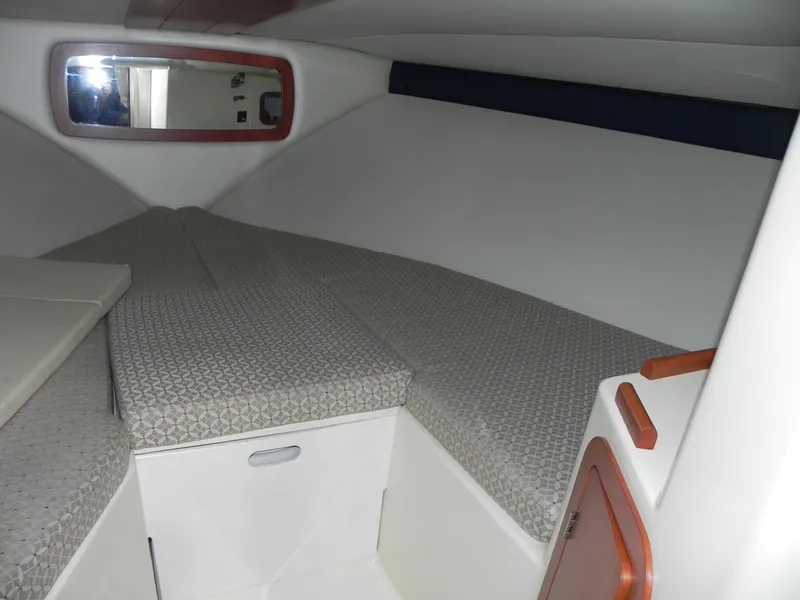 Slide: The Image of 2015 Chris-Craft 28 Heritage Corsair cabin interior with cushioned seating and storage. - 25