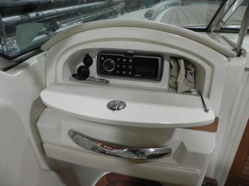 Slide: The Image of 2015 Chris-Craft 28 Heritage Corsair dashboard with stereo system and storage compartment. - 29