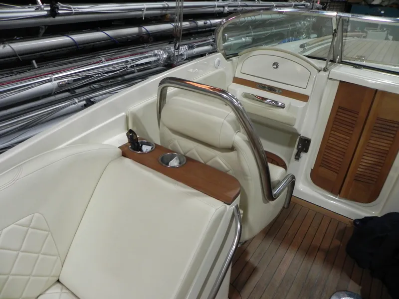Slide: The Image of 2015 Chris-Craft 28 Heritage Corsair interior with luxurious seating and wood accents. - 32