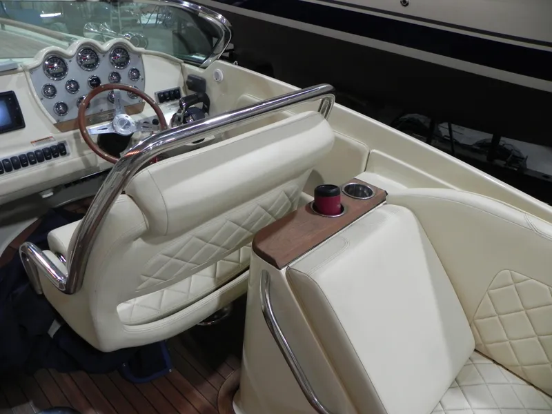 Slide: The Image of 2015 Chris-Craft 28 Heritage Corsair interior with cream leather seats and wooden dashboard. - 33