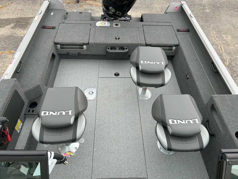 Slide: The Image of 2025 Lund 1875 Impact XS Fish boat interior with seating and storage compartments. - 2