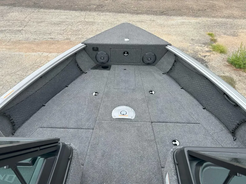 Slide: The Image of 2025 Lund 1875 Impact XS Fish boat interior with gray carpet and storage compartments. - 4