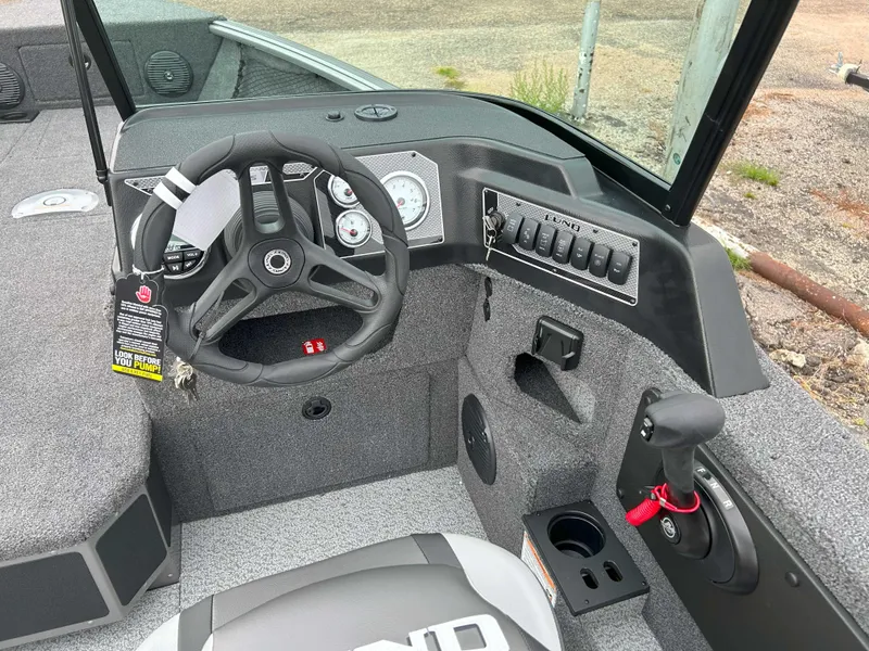 Slide: The Image of 2025 Lund 1875 Impact XS Fish boat interior with steering wheel and controls. - 5