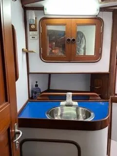 Slide: The Image of 1984 Tayana 55 yacht interior sink and cabinet area. - 15