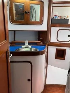 Slide: The Image of Interior of 1984 Tayana 55 sailboat with wooden cabinets and compact sink. - 17