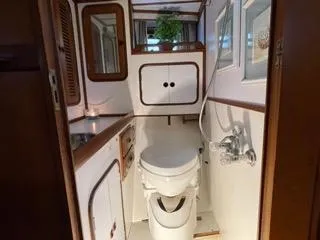 Slide: The Image of 1984 Tayana 55 yacht bathroom with wooden accents and white fixtures - 19