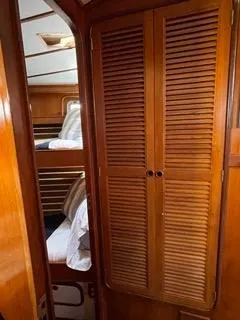 Slide: The Image of Interior of 1984 Tayana 55 sailboat with wooden cabinetry and bunk beds. - 27