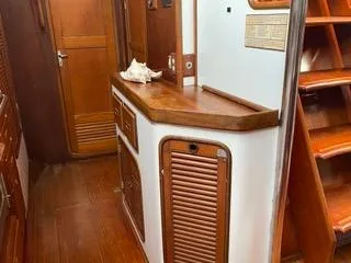 Slide: The Image of Interior of 1984 Tayana 55 sailboat with wooden cabinetry and stairs. - 3