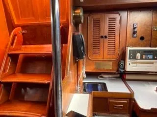 Slide: The Image of Interior of 1984 Tayana 55 sailboat with wooden stairs and cabinetry. - 31