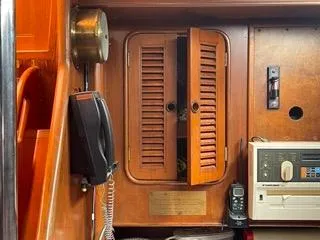 Slide: The Image of Interior of 1984 Tayana 55 sailboat with wooden cabinets and communication devices. - 35