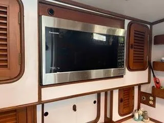 Slide: The Image of Built-in microwave in the galley of a 1984 Tayana 55 sailboat. - 5