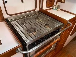 Slide: The Image of Stainless steel stove and oven in the galley of a 1984 Tayana 55 sailboat. - 6