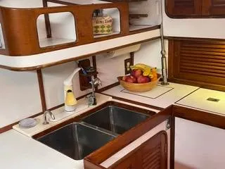 Slide: The Image of Galley kitchen in 1984 Tayana 55 sailboat with double sink and fruit bowl. - 9