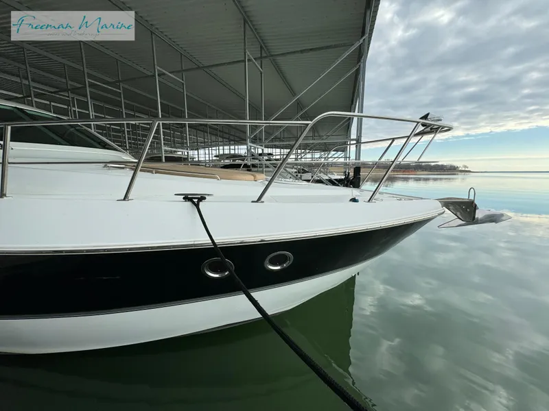 Slide: The Image of 2014 Cruisers Yachts 540 Sports Coupe docked in a marina. - 30