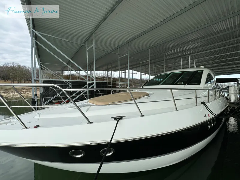 Slide: The Image of 2014 Cruisers Yachts 540 Sports Coupe docked under a covered marina. - 40
