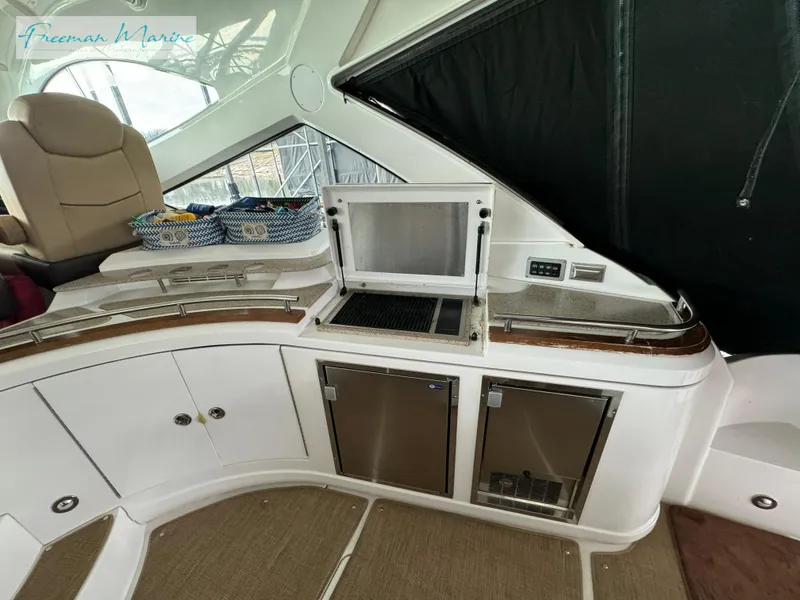 Slide: The Image of 2014 Cruisers Yachts 540 Sports Coupe interior with kitchenette and seating area. - 44