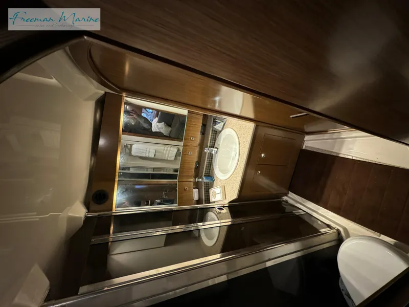 Slide: The Image of 2014 Cruisers Yachts 540 Sports Coupe bathroom with modern fixtures and wood accents. - 24