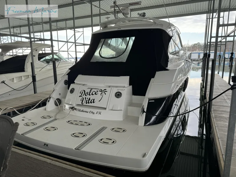 Slide: The Image of 2014 Cruisers Yachts 540 Sports Coupe docked, rear view with Dolce Vita nameplate. - 27