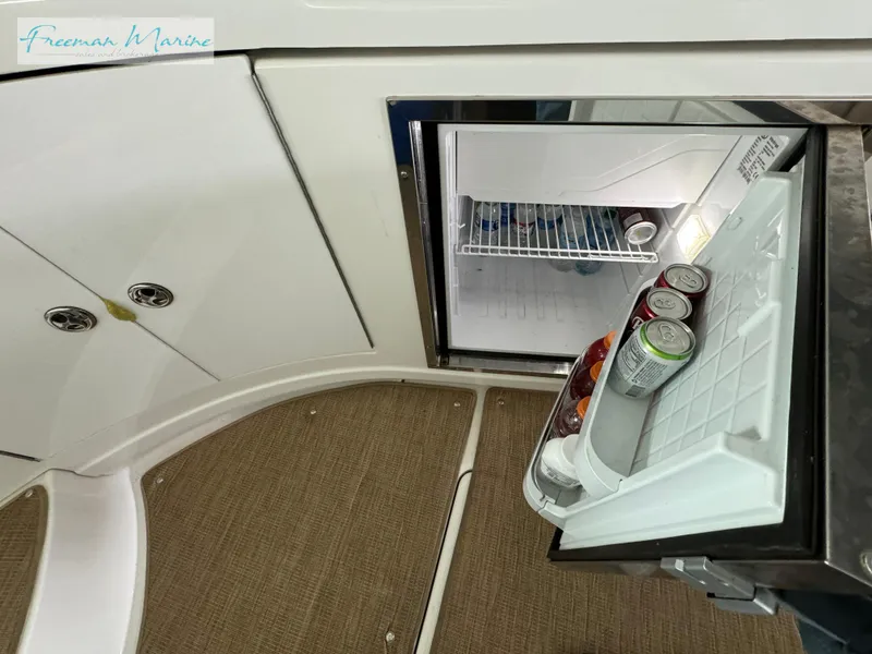 Slide: The Image of Open mini fridge on 2014 Cruisers Yachts 540 Sports Coupe with drinks inside. - 46