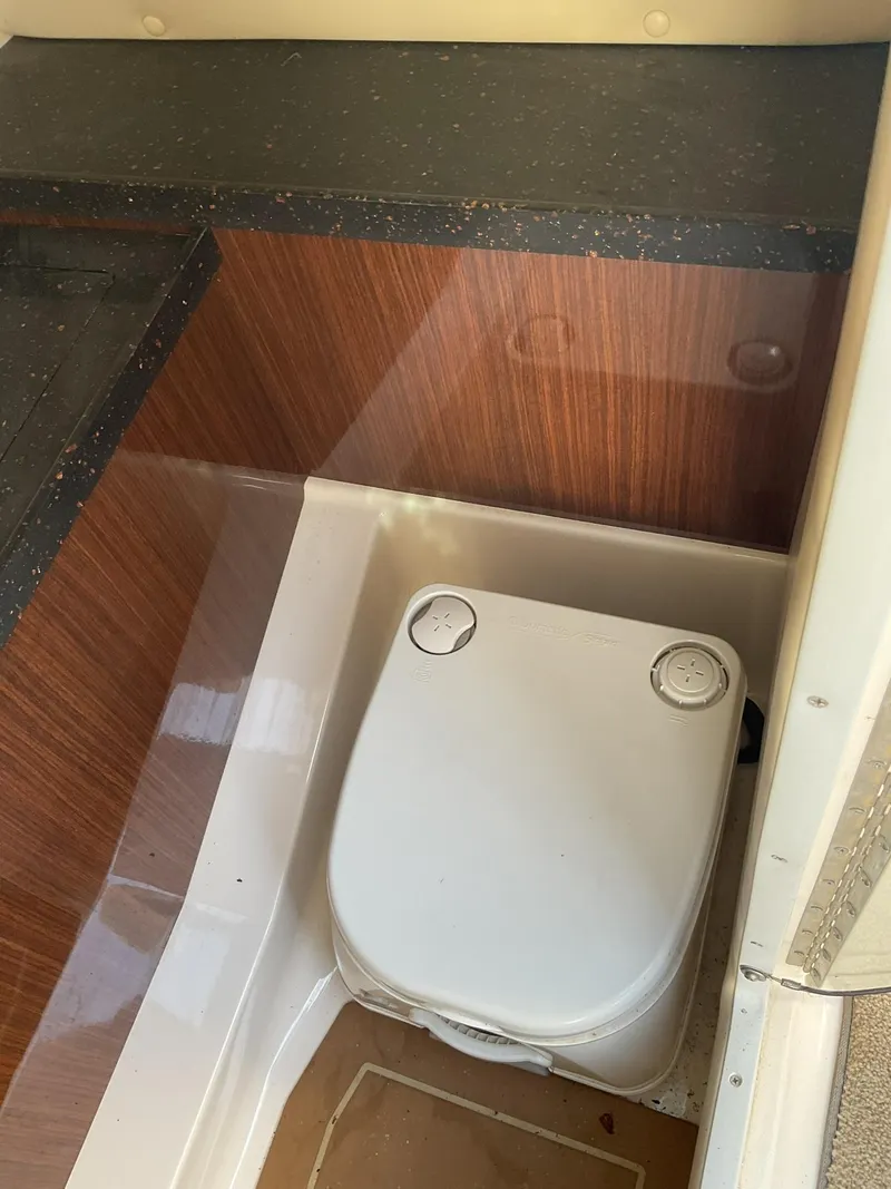 Slide: The Image of 2013 Regal 27 FasDeck RX boat interior with compact toilet. - 10