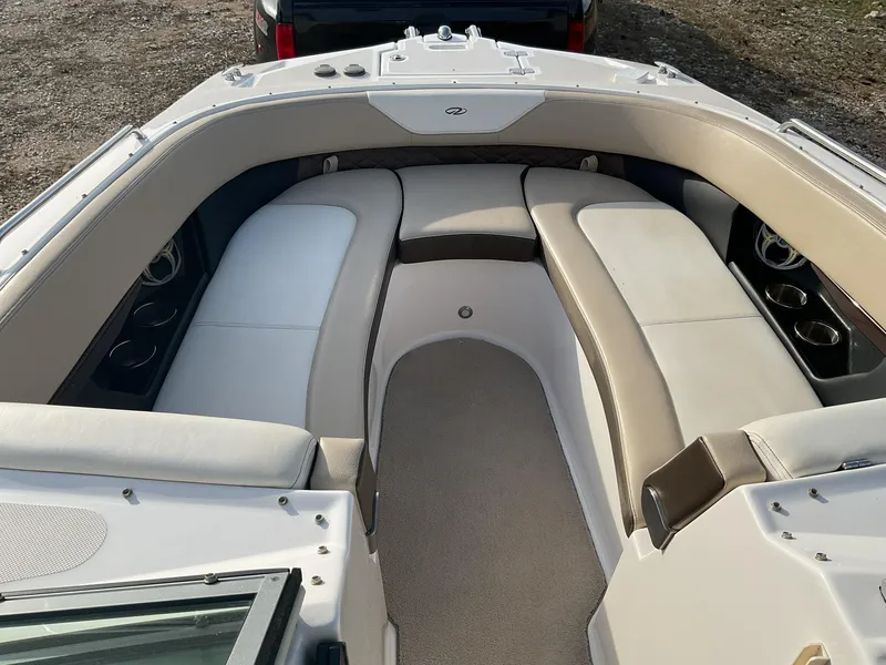 Slide: The Image of 2013 Regal 27 FasDeck RX boat interior with cushioned seating. - 12