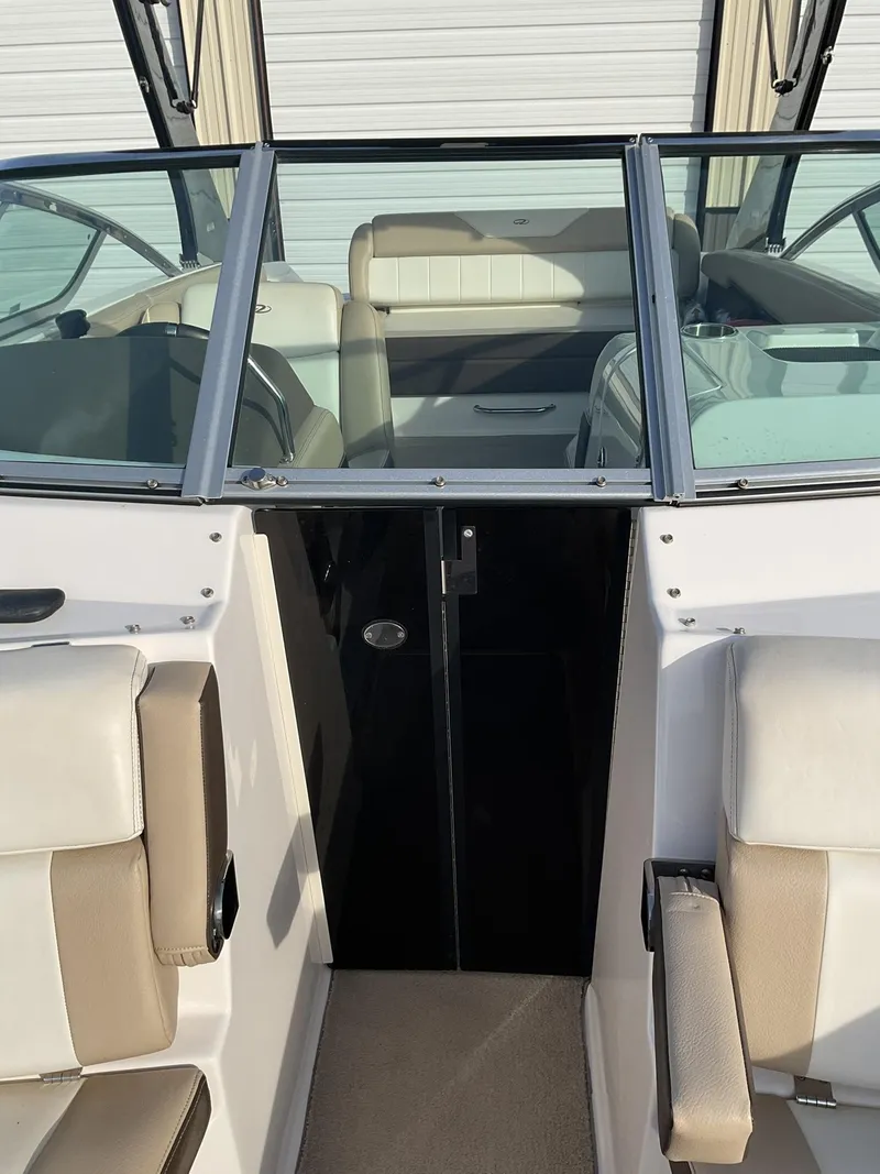 Slide: The Image of 2013 Regal 27 FasDeck RX boat interior with beige and white seating. - 13