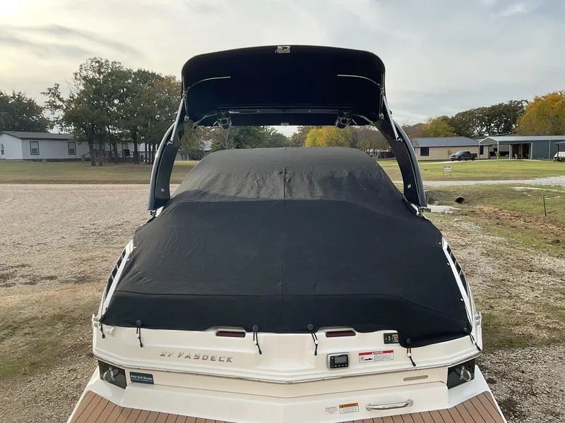 Slide: The Image of 2013 Regal 27 FasDeck RX boat with black cover, rear view. - 16