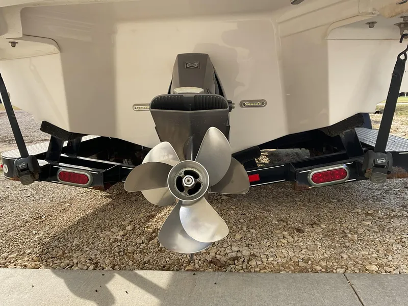 Slide: The Image of 2013 Regal 27 FasDeck RX boat stern with propeller and trailer. - 2