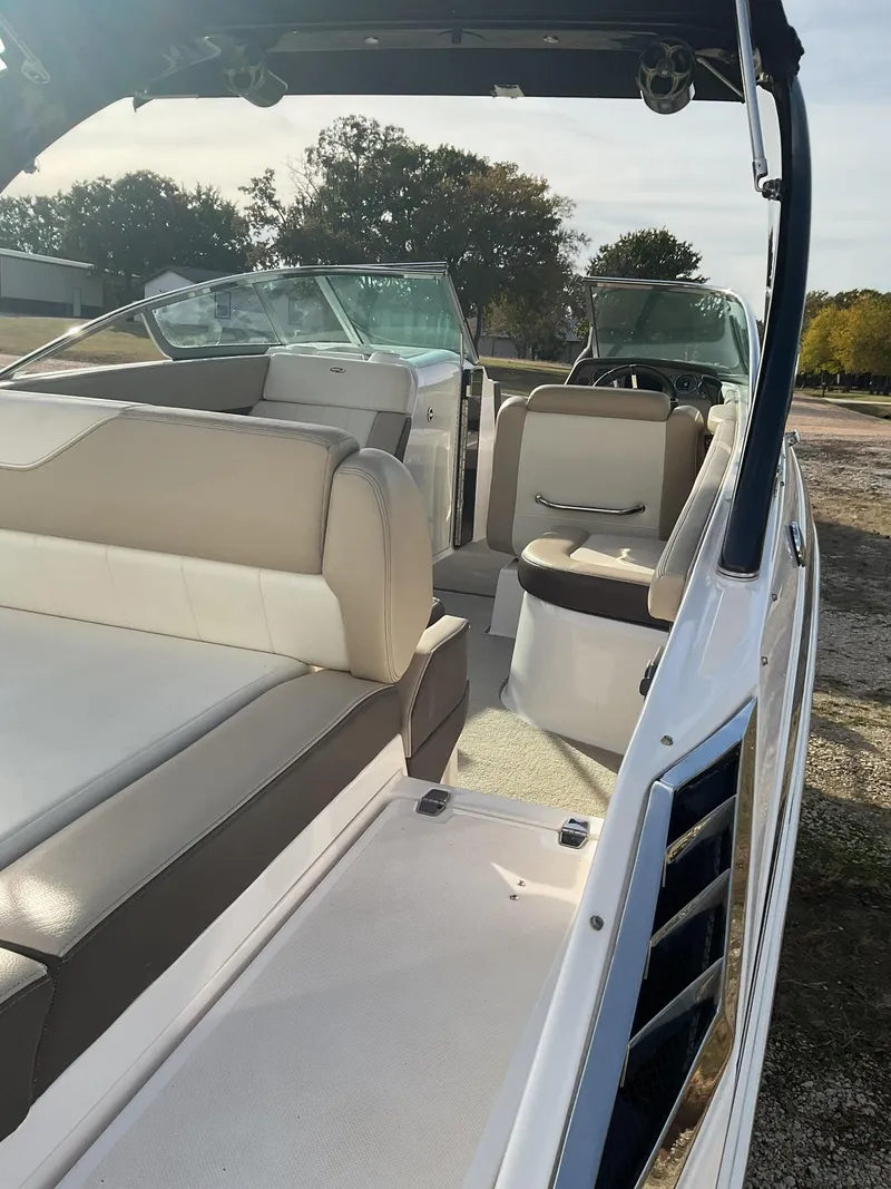 Slide: The Image of 2013 Regal 27 FasDeck RX boat interior with beige and white seating. - 3