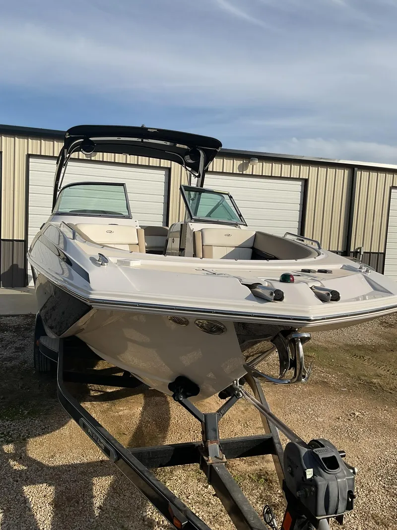 Slide: The Image of 2013 Regal 27 FasDeck RX boat on trailer in front of storage units. - 4