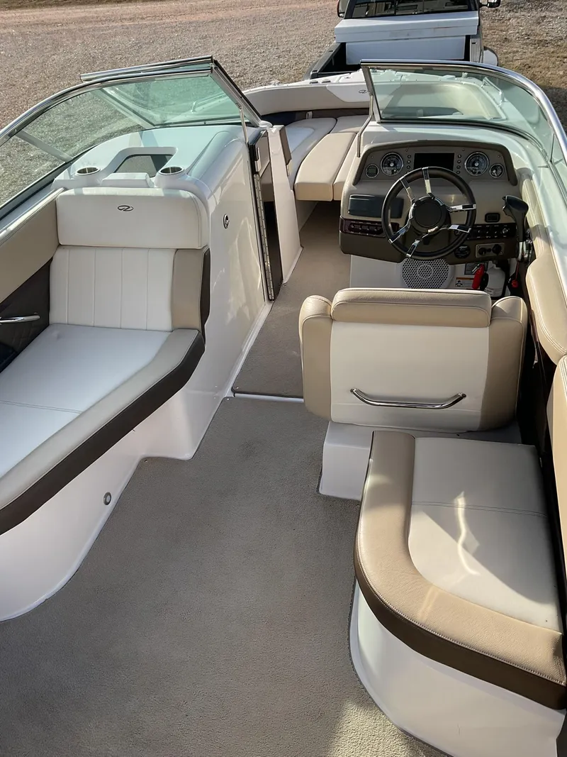 Slide: The Image of 2013 Regal 27 FasDeck RX boat interior with beige and white seating. - 8