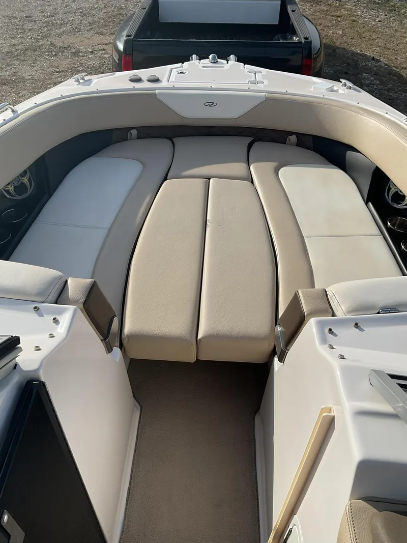 Slide: The Image of 2013 Regal 27 FasDeck RX boat interior with cushioned seating. - 9