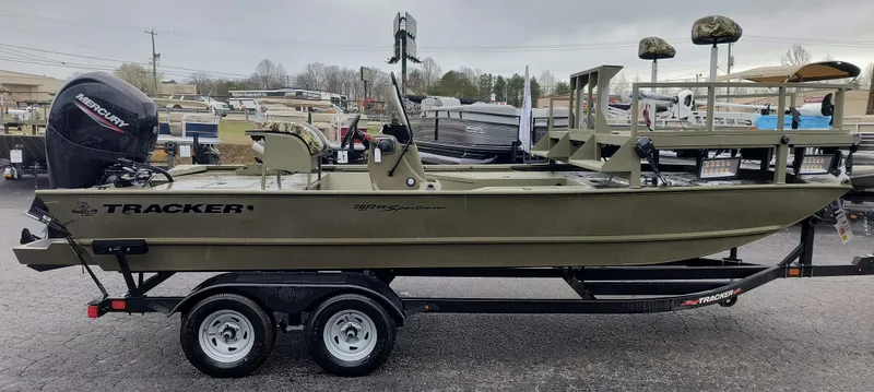 Slide: The Image of 2024 Tracker Grizzly 2072 CC Sportsman boat on a trailer in a dealership lot. - 4